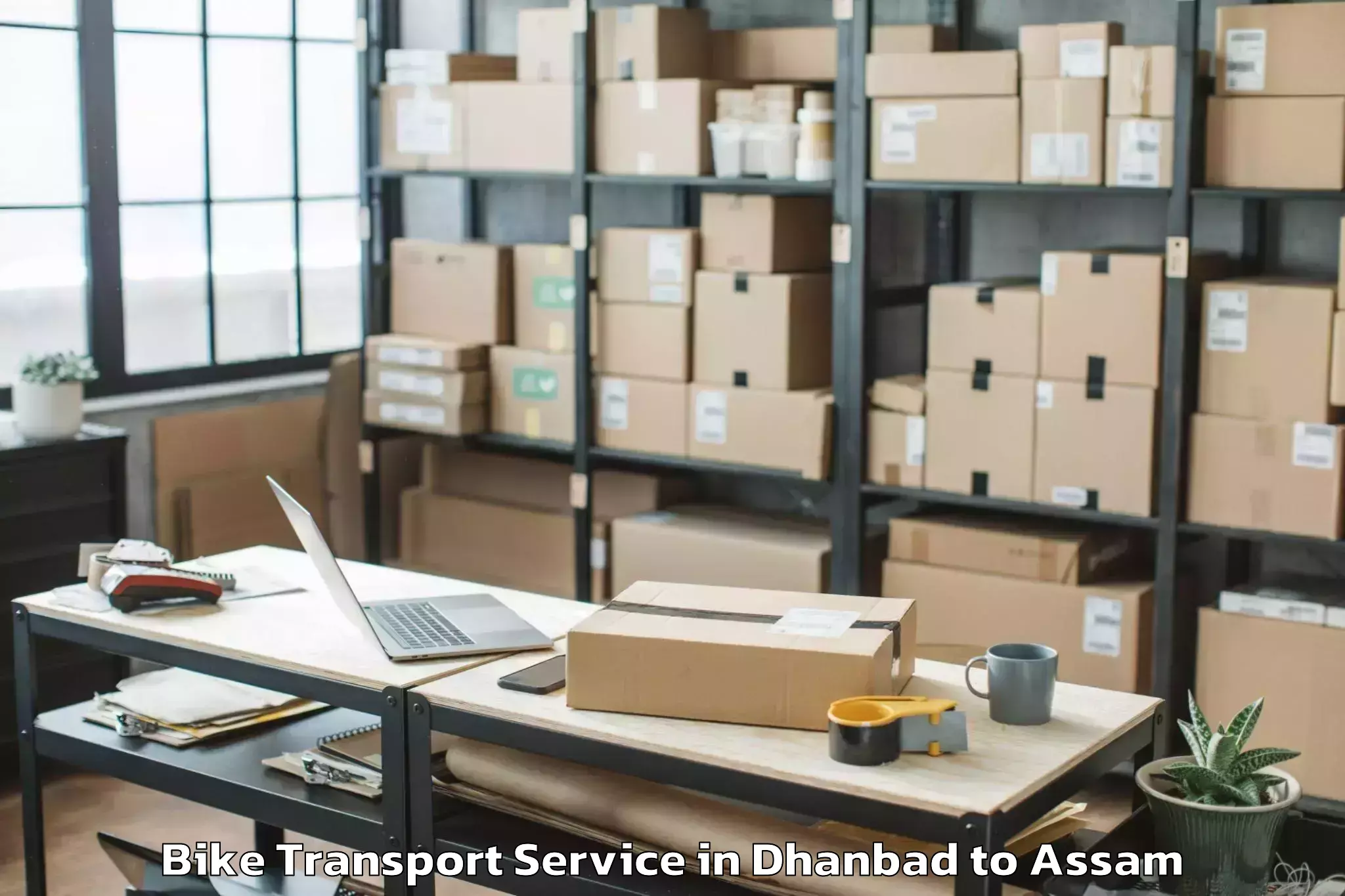 Leading Dhanbad to Dergaon Bike Transport Provider